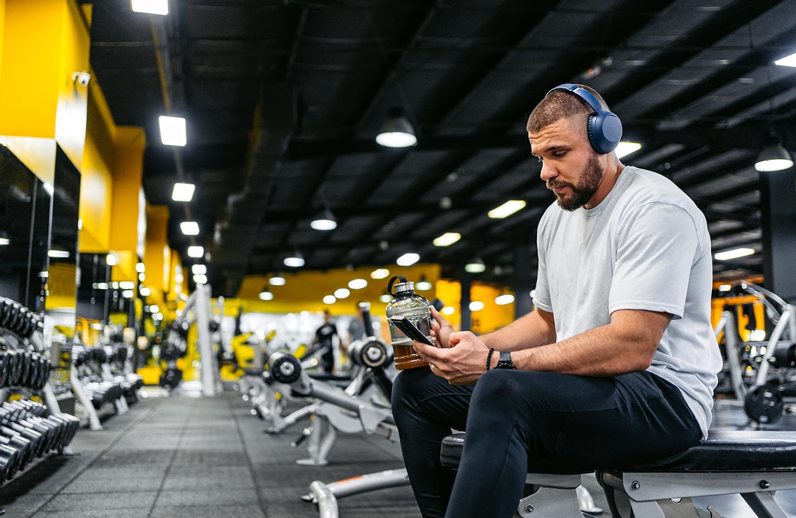 A person helping a person in a wheelchair lifting weights

Description automatically generated